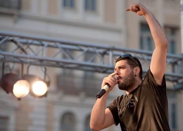 In this photo dated June 21, 2011, Greek rapper Pavlos Fyssas performs on stage. Fyssas, a hip-hop singer with the stage name Killah P and described as an anti-fascist activist, died early Wednesday Sept 18 from two stab wounds to the chest after leaving a cafe in the western area of Keratsini, Greece. Police arrested a suspect at the scene, who they say admitted to the killing and identified himself as a member of Golden Dawn. (AP Photo/John D. Carnessiotis)